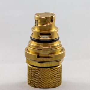 a gold metal object with black rings Paccar 2023 Plug 1